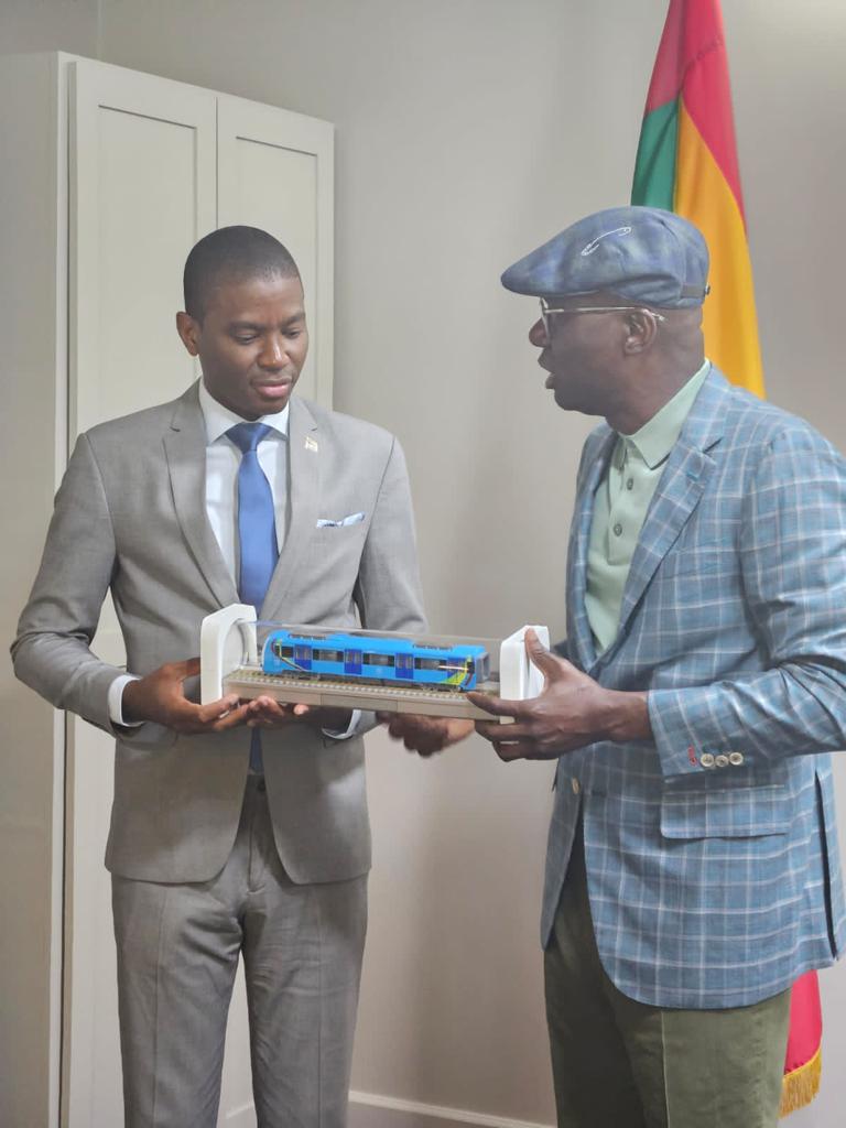 Lagos State Governor Mr Babajide Sanwo-Olu presents a miniature of the Blue Line train to Grenadian Prime Minister Dickon Michelle